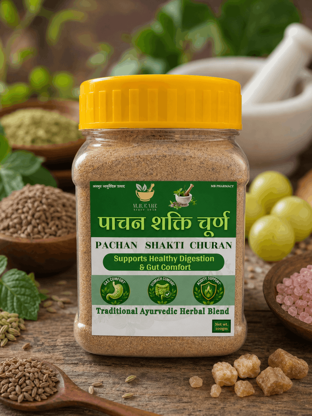 Jar of Pachan Shakti Churan with a yellow lid on a wooden surface with herbs and grains.